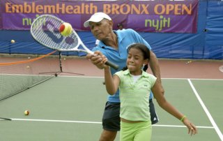 kiddies practice at the playing tennis camp in Crotona Park.
